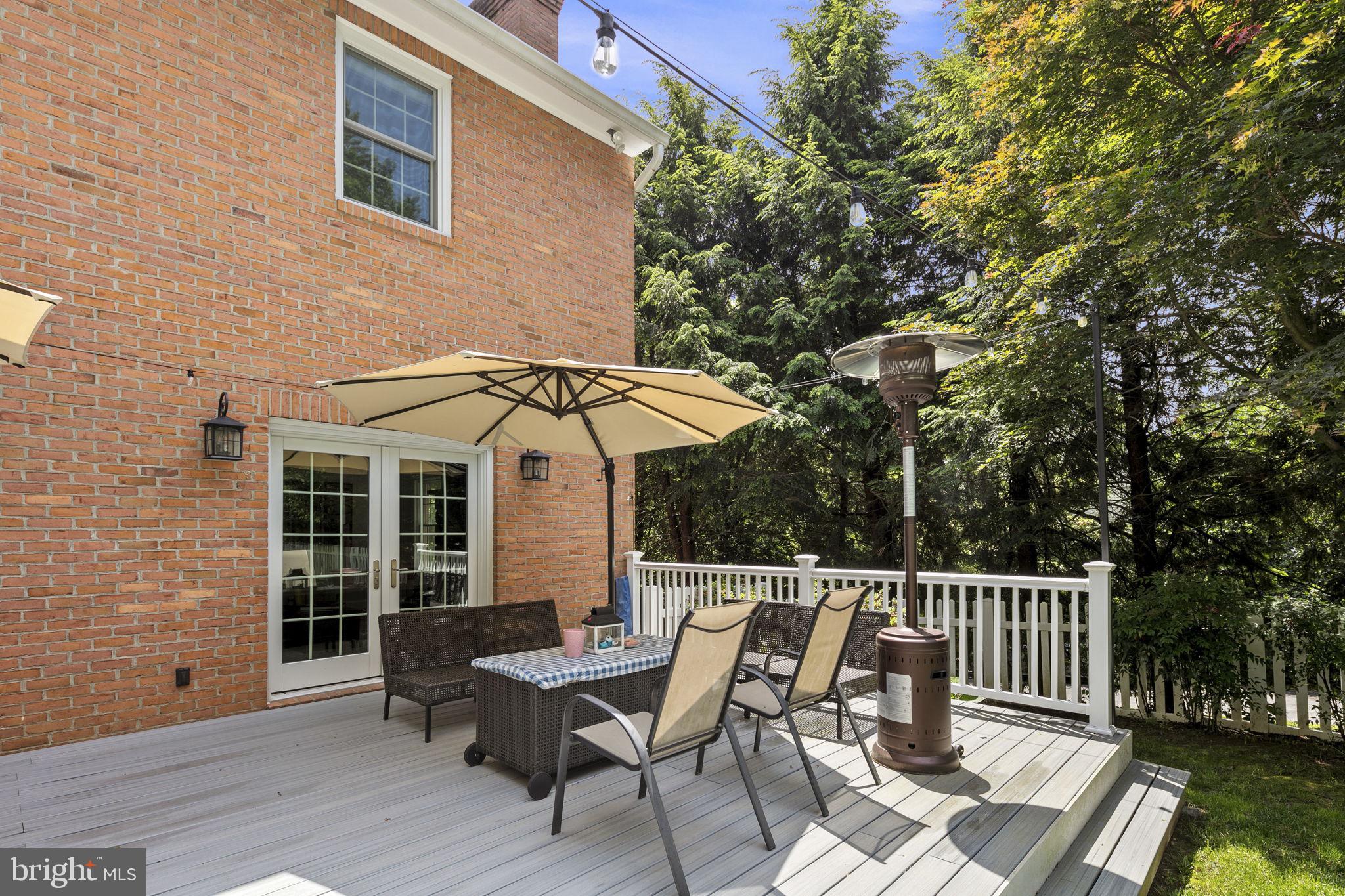 6916 Seven Locks Road Cabin John, MD 20818 - Photo 28 of 38 a view of a patio with table and chairs and wooden floor