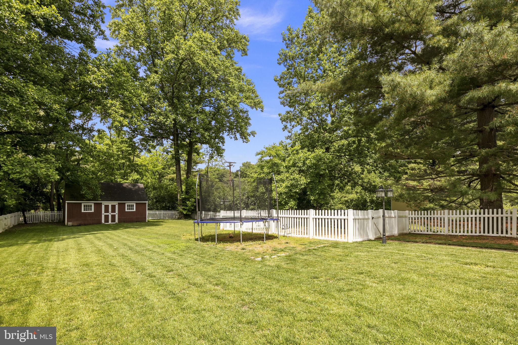 6916 Seven Locks Road Cabin John, MD 20818 - Photo 29 of 38 a view of a swimming pool with a bench and trees