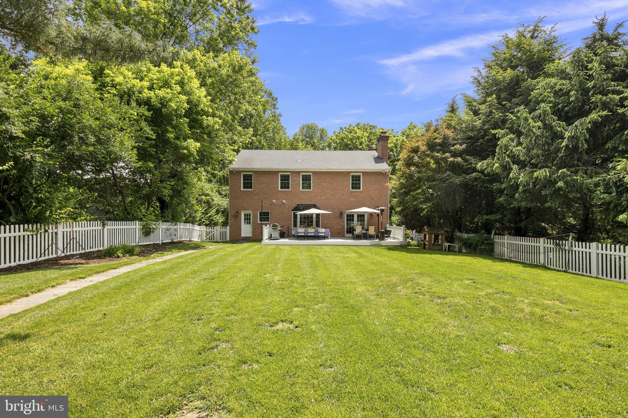 6916 Seven Locks Road Cabin John, MD 20818 - Photo 30 of 38 a swimming pool with outdoor seating and yard