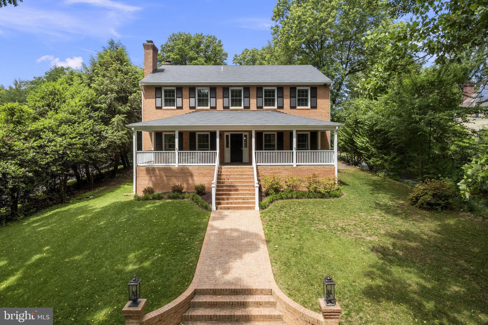 6916 Seven Locks Road Cabin John, MD 20818 - Photo 3 of 38 a front view of a house with a yard