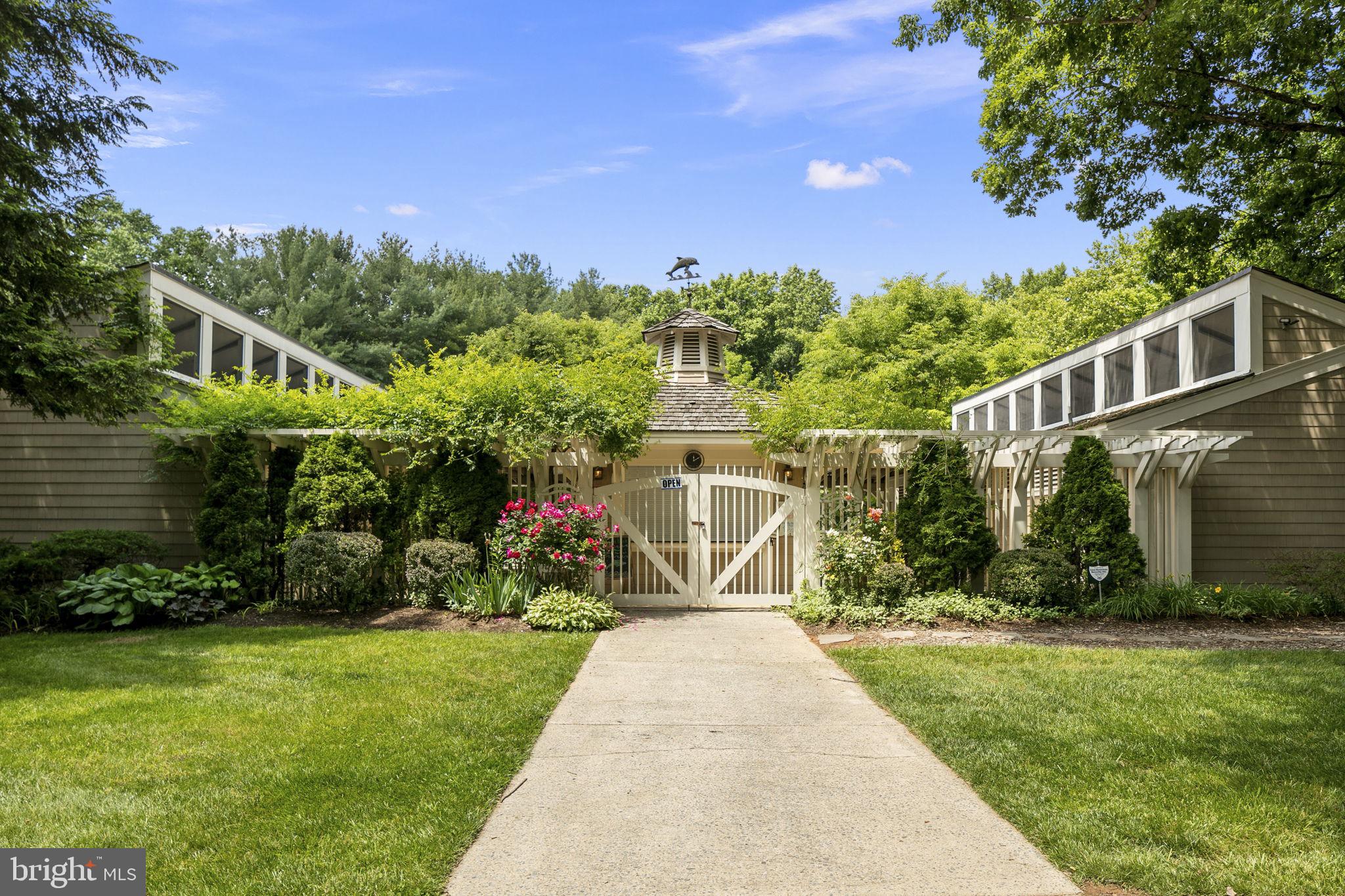 6916 Seven Locks Road Cabin John, MD 20818 - Photo 32 of 38 a front view of a house with a yard