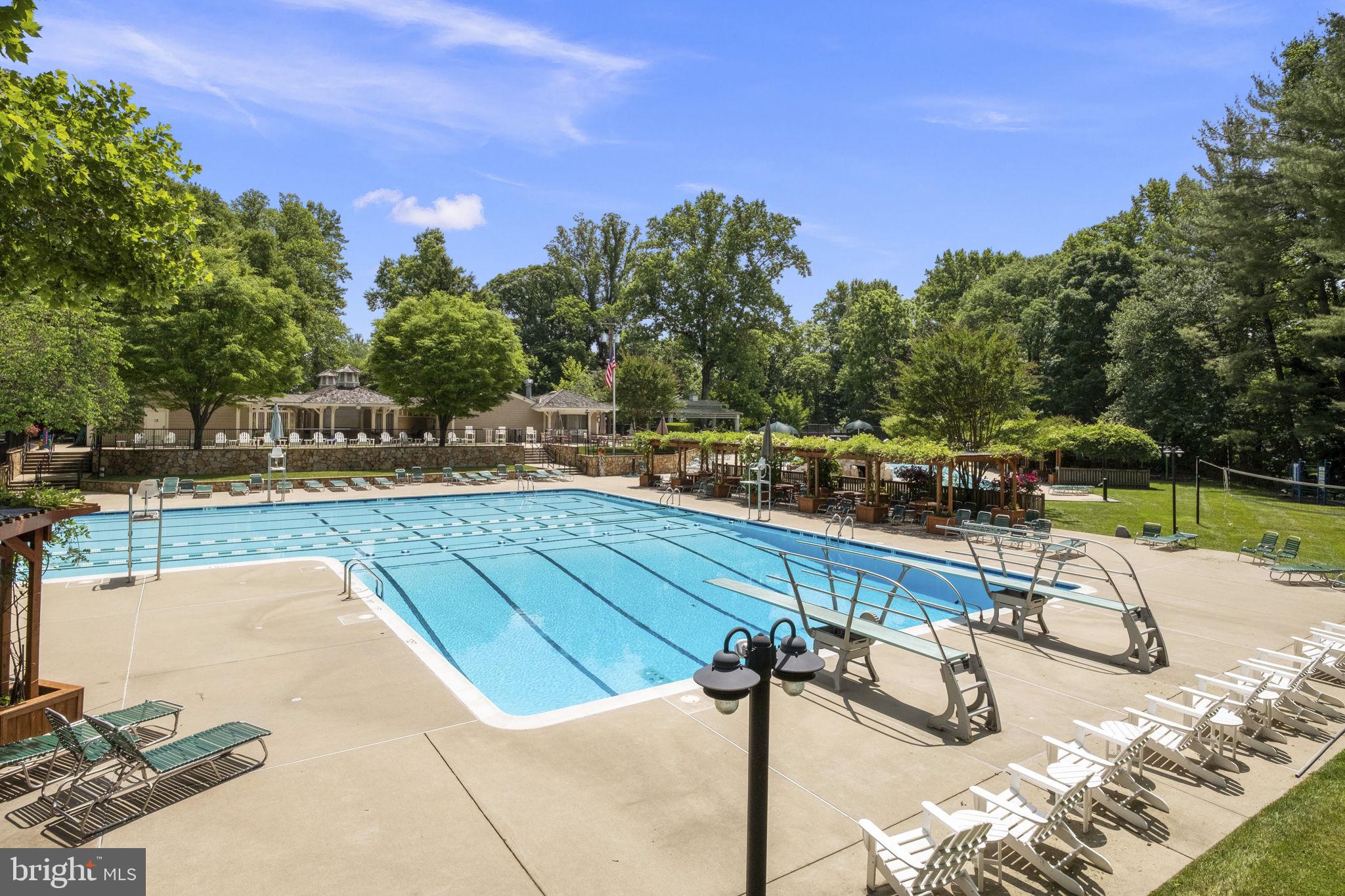 6916 Seven Locks Road Cabin John, MD 20818 - Photo 33 of 38 a view of a swimming pool with a lounge chairs