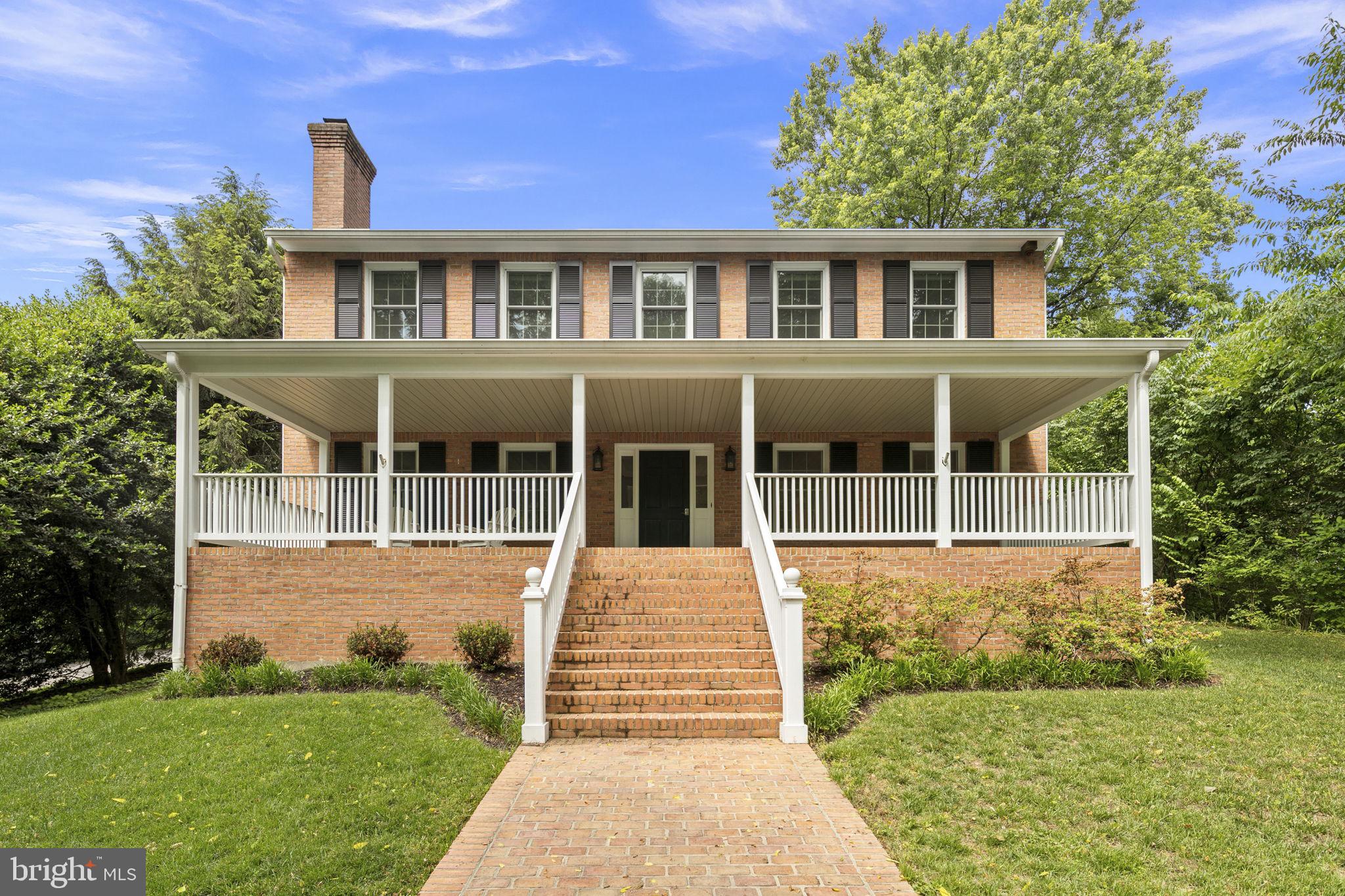 6916 Seven Locks Road Cabin John, MD 20818 - Photo 37 of 38 a front view of a house with a yard