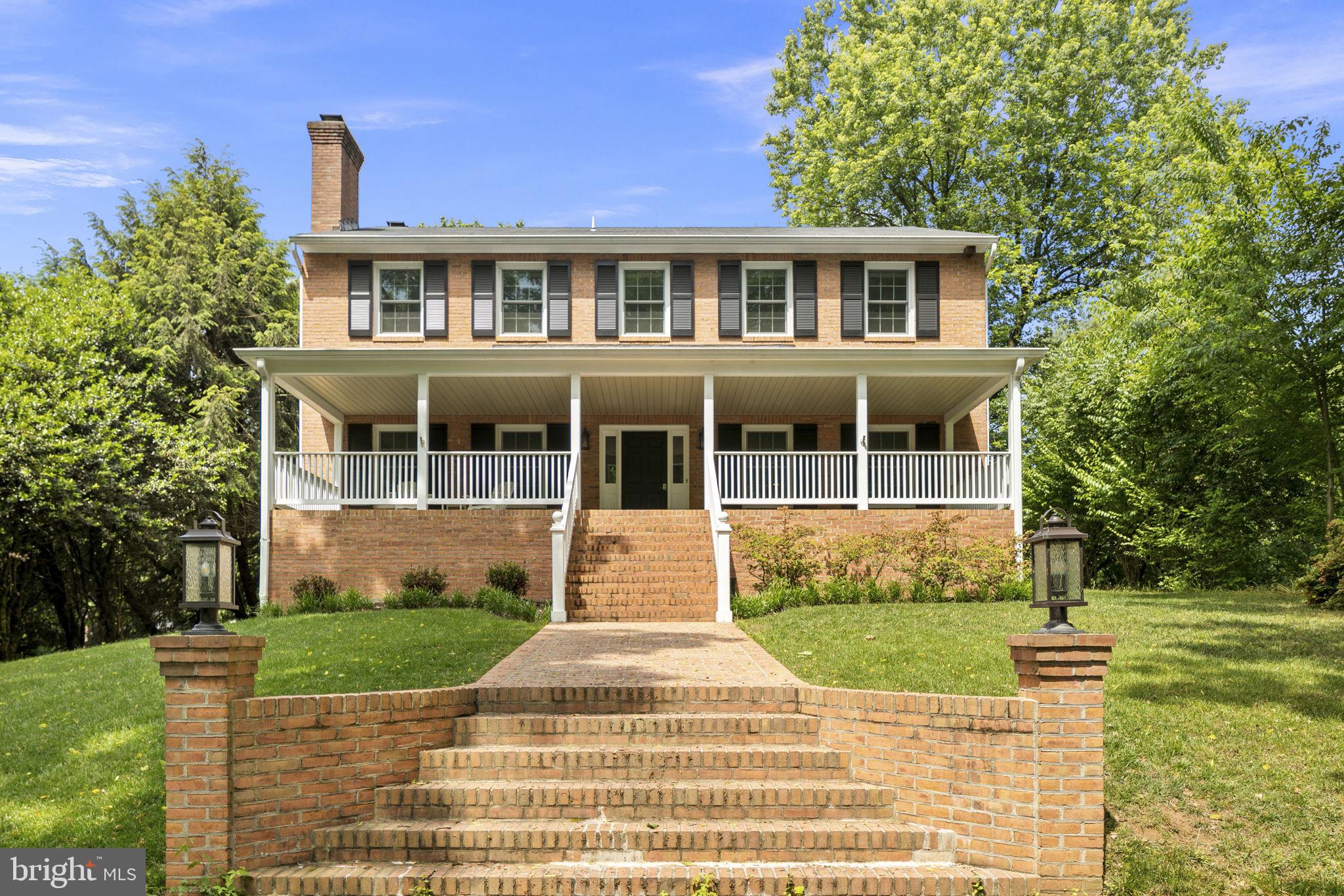 6916 Seven Locks Road Cabin John, MD 20818 - Photo 4 of 38 a front view of a house with a yard