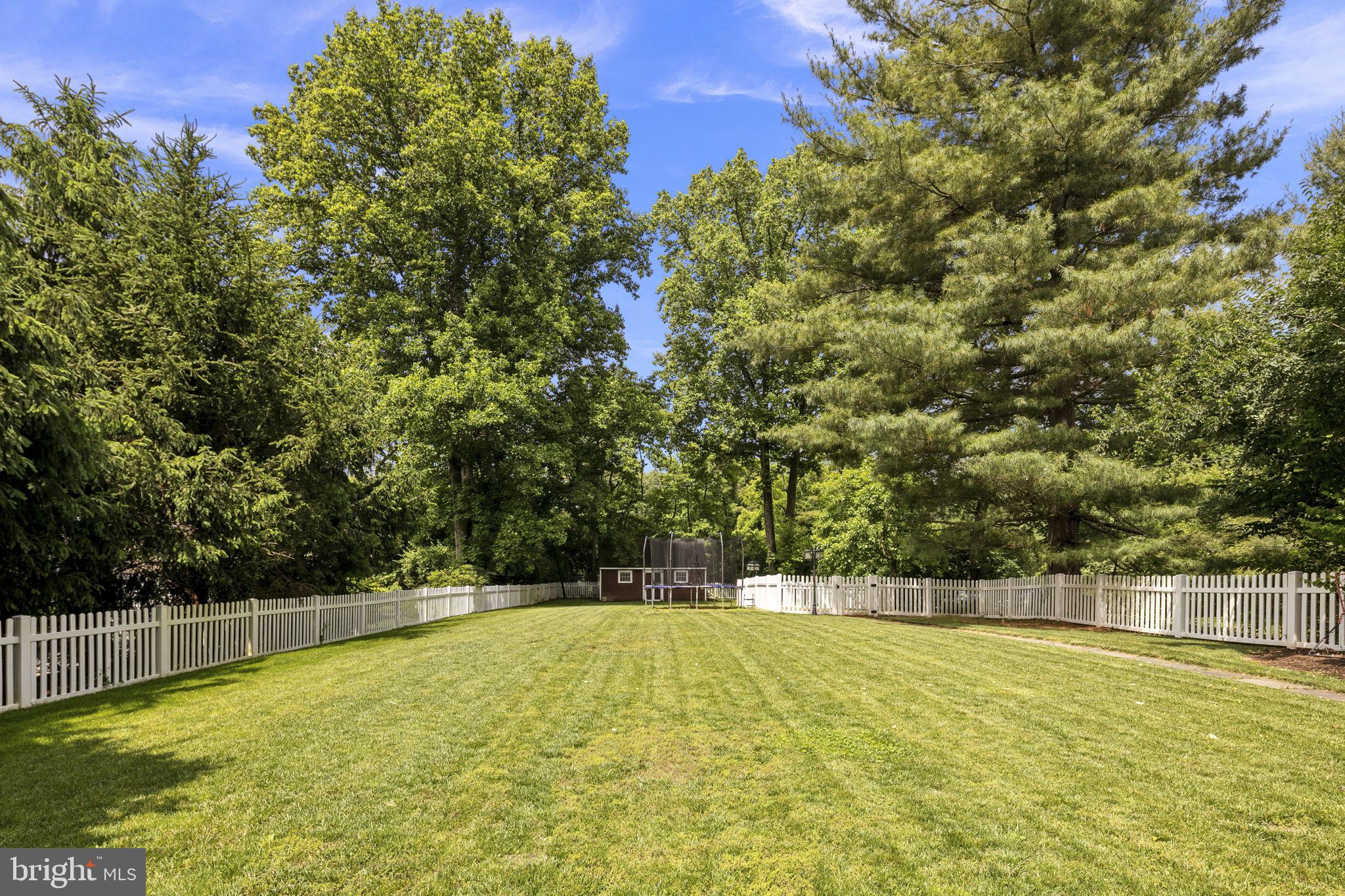 6916 Seven Locks Road Cabin John, MD 20818 - Photo 6 of 38 a view of a swimming pool with an outdoor seating and a yard