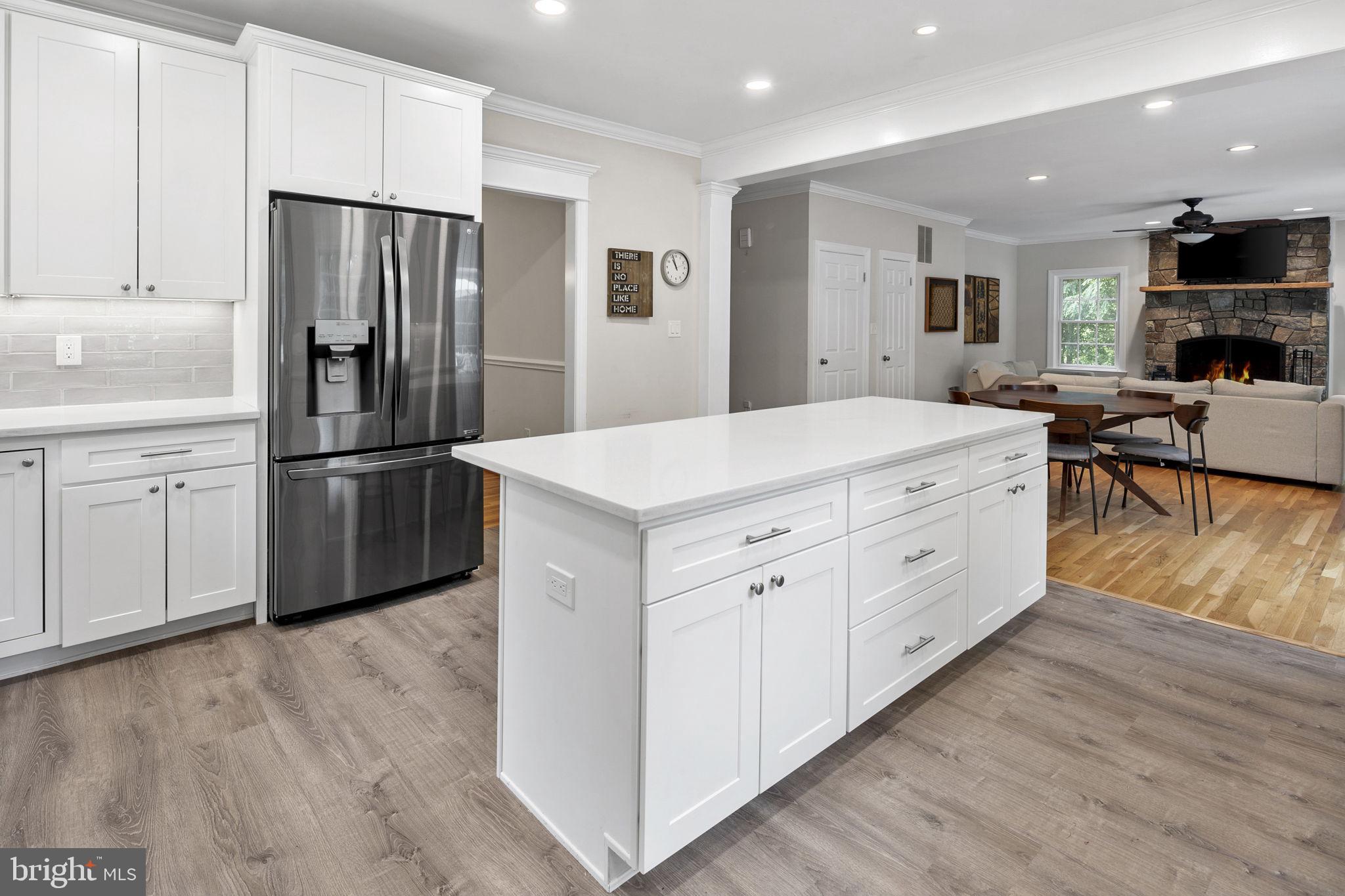 6916 Seven Locks Road Cabin John, MD 20818 - Photo 9 of 38 a kitchen with stainless steel appliances a refrigerator sink and cabinets