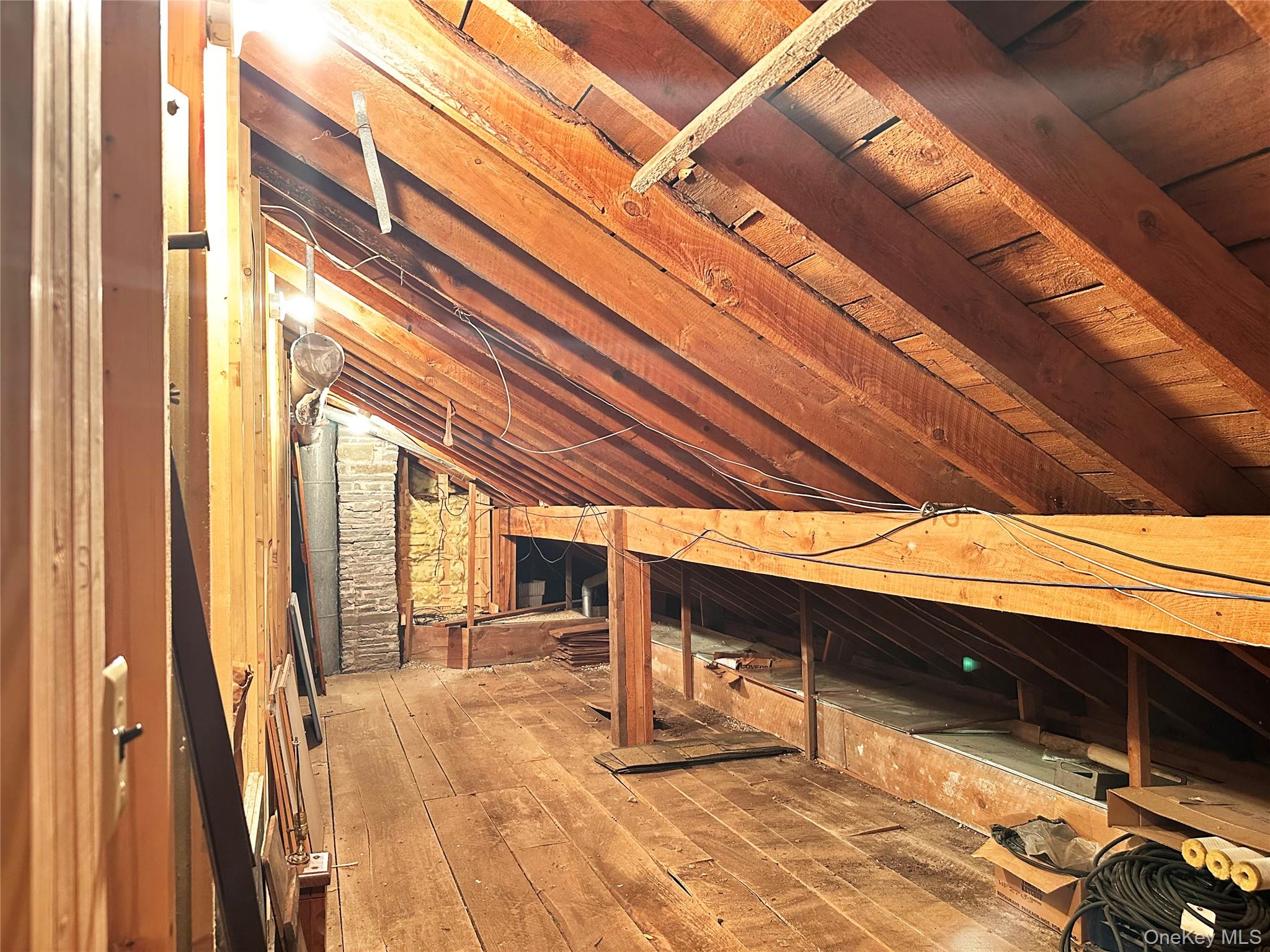 818 Methol Road Roscoe, NY 12776 - Photo 35 of 39 Walk-up attic storage area with exposed wood framing and substantial additional space for seasonal storage.