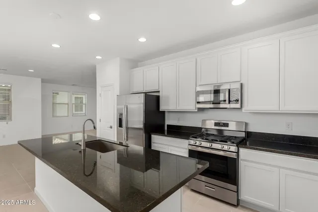 a kitchen with a sink and stainless steel appliances
