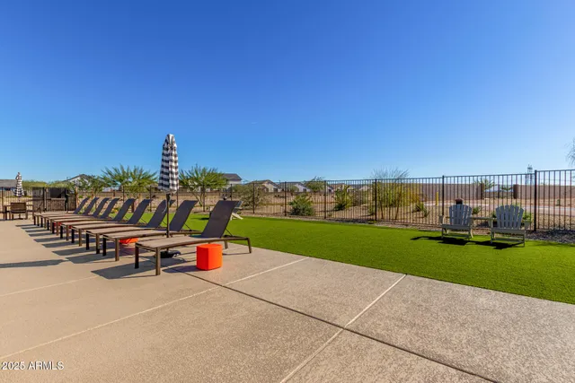 a view of a swimming pool with an outdoor seating