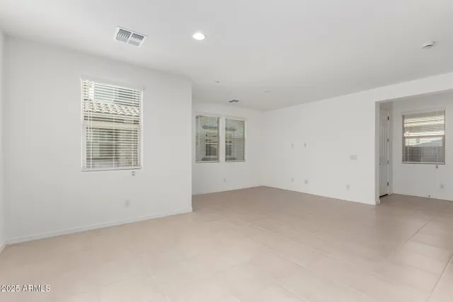 a view of an empty room with a kitchen