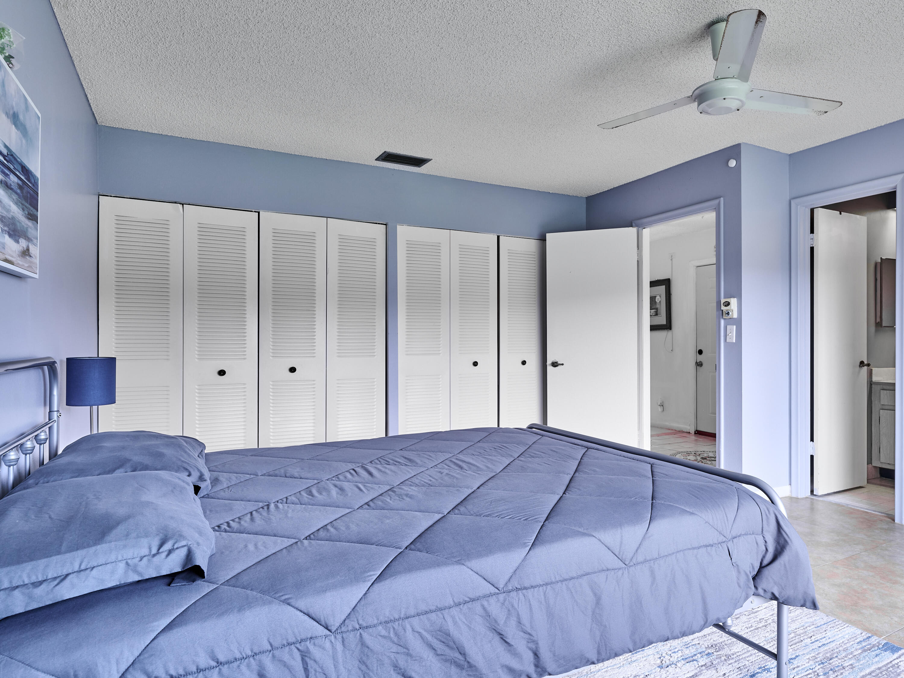 5197 Minto Road Boynton Beach, FL 33472 - Photo 15 of 32 a bedroom with a large bed and a chandelier
