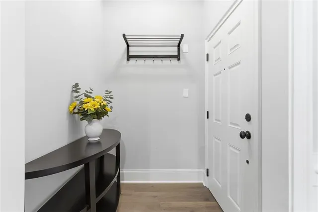 a kitchen with kitchen island granite countertop a sink cabinets and wooden floor