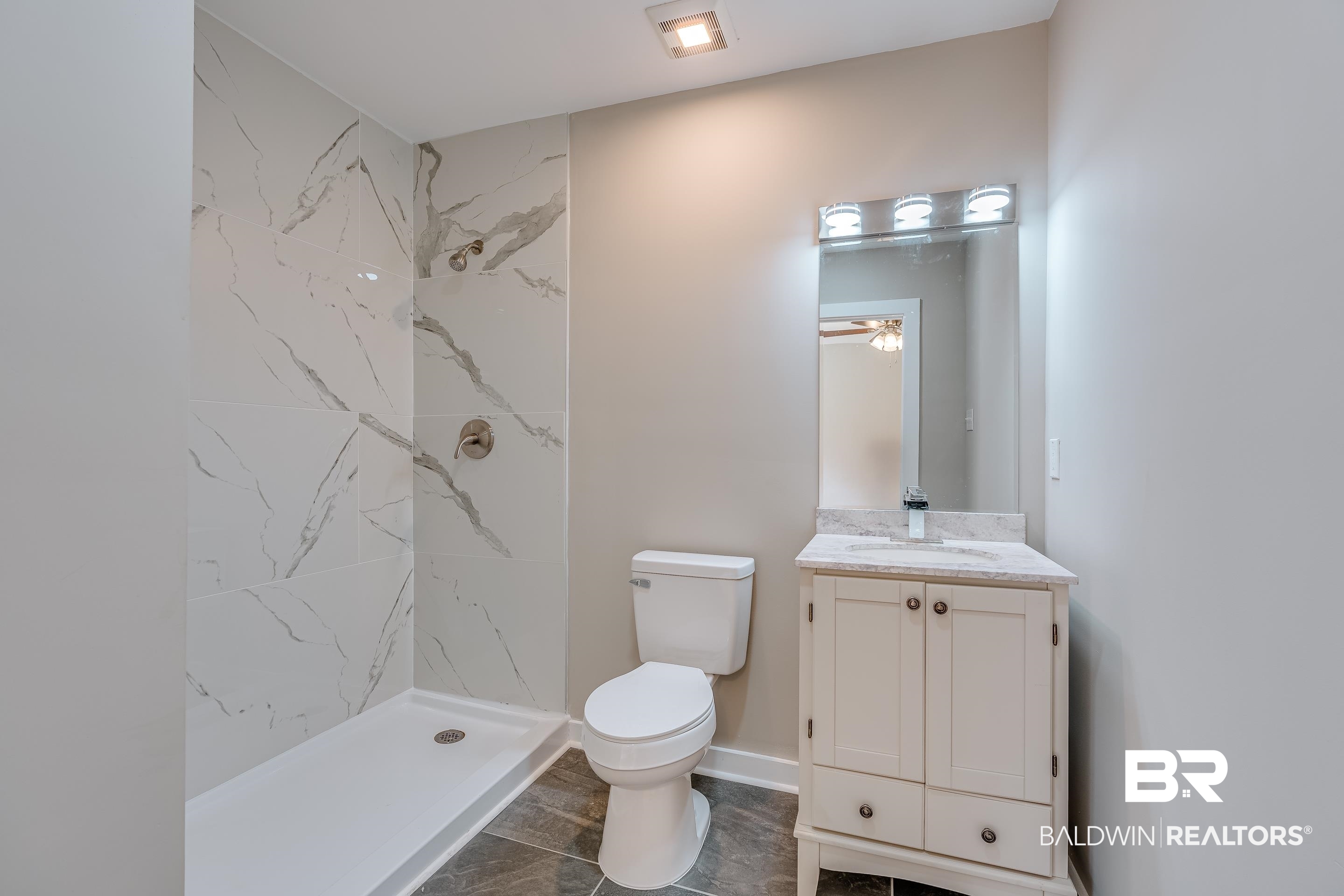 8001 16th Street Irvington, AL 36544 - Photo 24 of 35 Bathroom featuring vanity and a marble finish shower