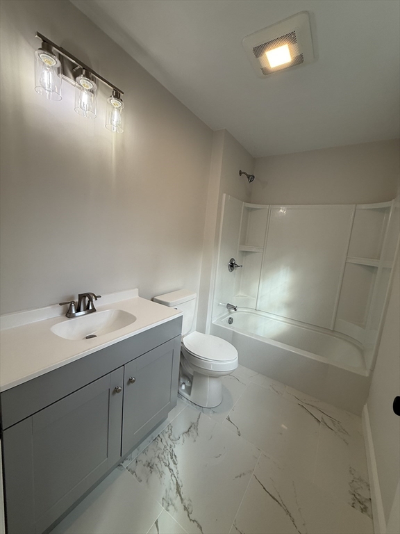 63 North Street, Unit B Worcester, MA 01605 - Photo 13 of 19 a bathroom with a toilet sink and mirror