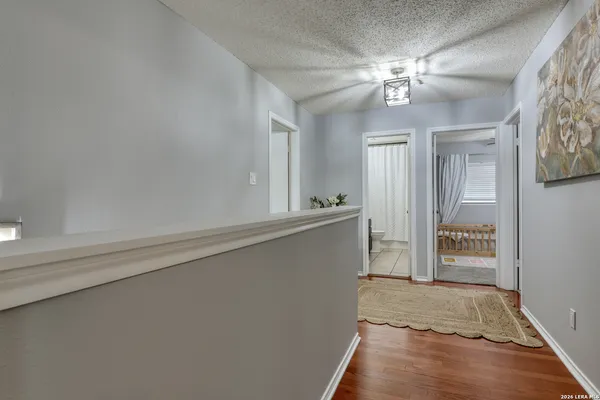 a view of an empty room with wooden floor