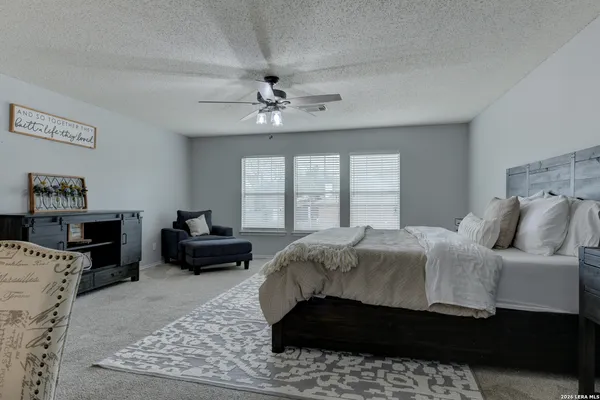 a bedroom with a large bed and a couch