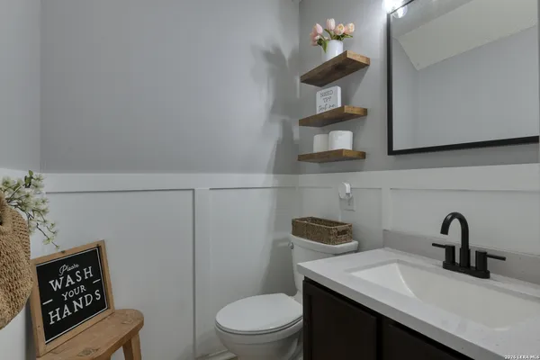 a bathroom with a toilet a sink and mirror