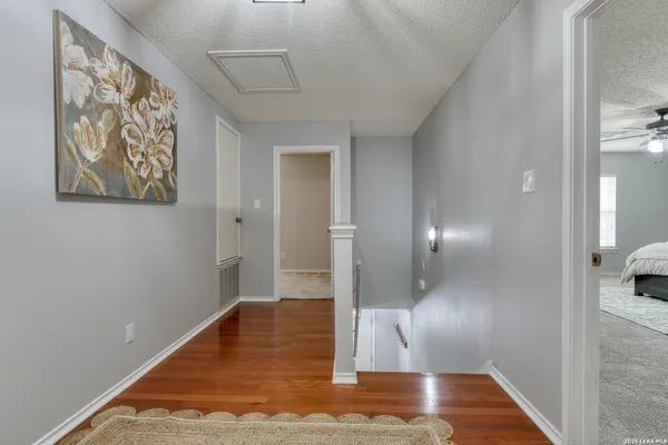 a view of a hallway with wooden floor