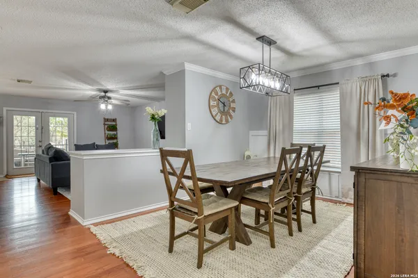 a view of a dining room and livingroom with furniture wooden floor a chandelier