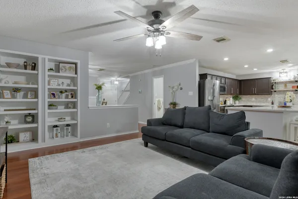 a living room with furniture and kitchen view