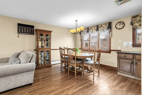 a living room with furniture a dining table and a large window