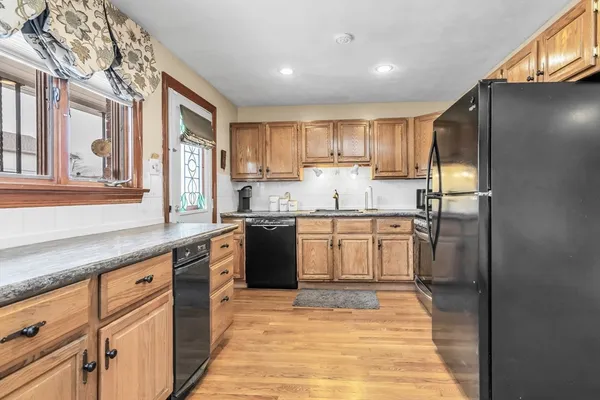 a kitchen with kitchen island granite countertop a sink appliances cabinets and counter space