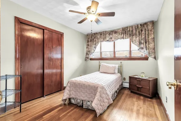a bedroom with a bed and a chandelier fan