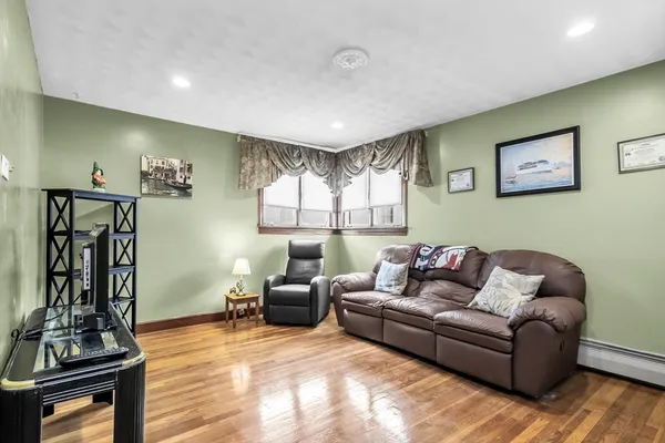 a living room with furniture and wooden floor