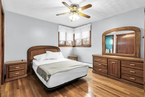 a bedroom with a bed and a dresser