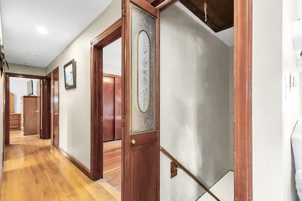a view of a porch with furniture and wooden floor