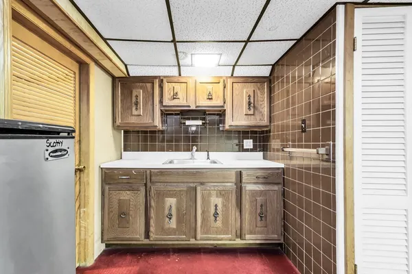 a bathroom with a toilet a window and a shower