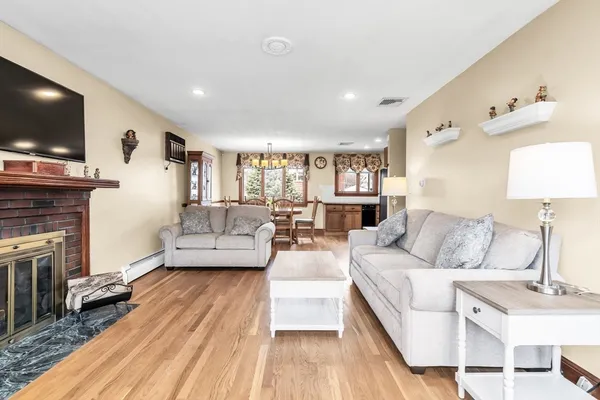 a living room with fireplace furniture and a flat screen tv
