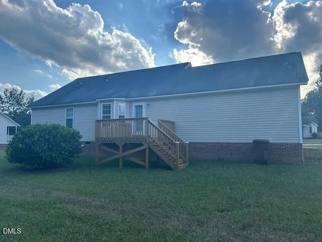 a view of a backyard with plants and a garden