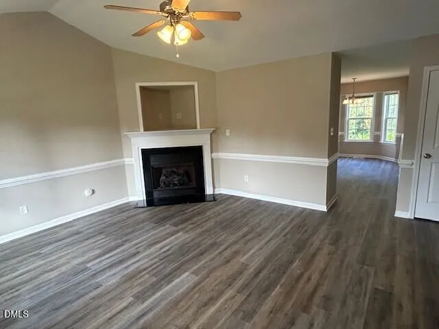 wooden floor fireplace and windows in an empty room