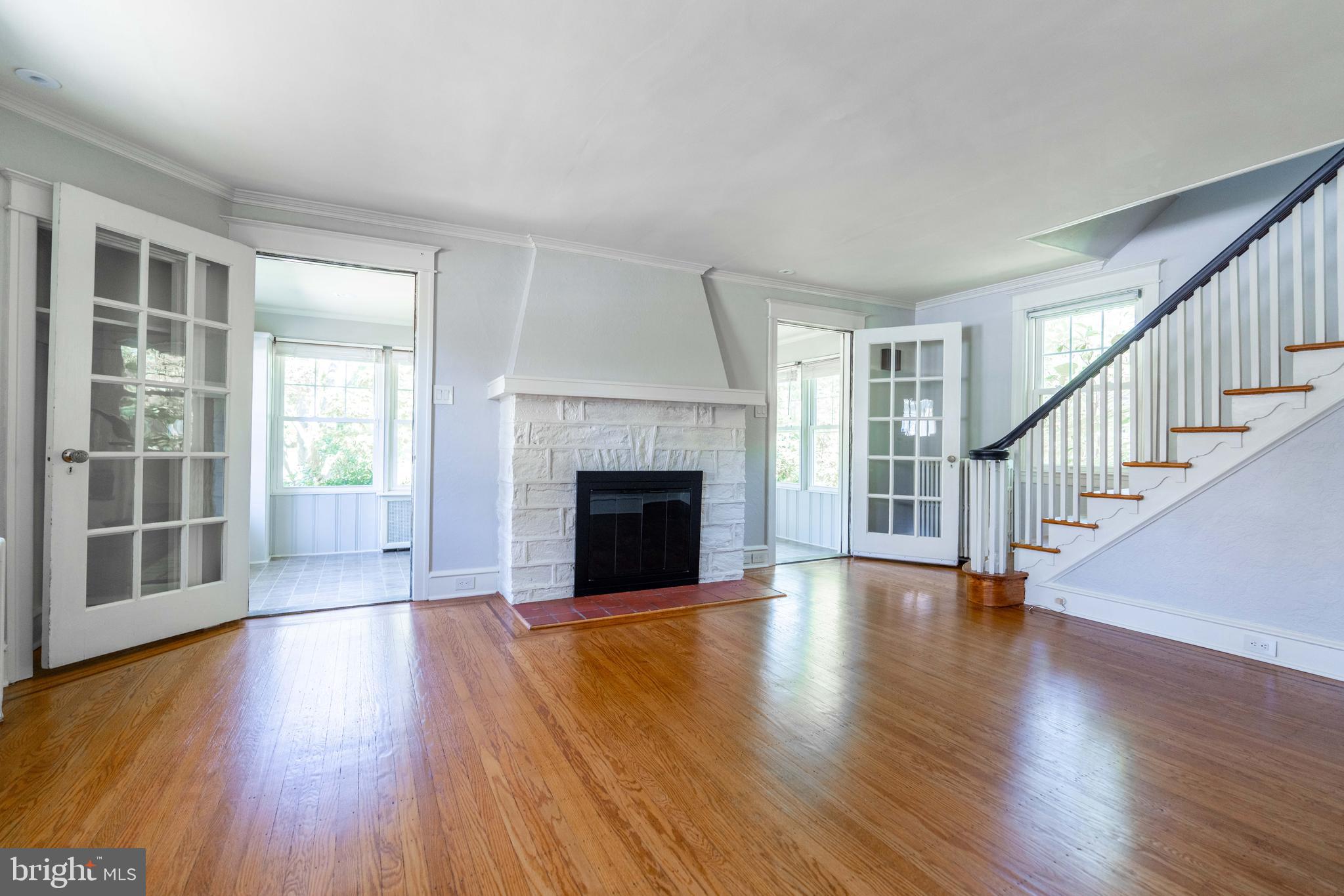 2114 East County Line Road Ardmore, PA 19003 - Photo 7 of 30 Living room w/ gas fireplace, looking into sunroom