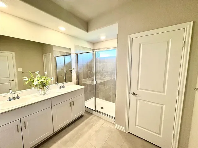 a bathroom with a double vanity sink and mirror