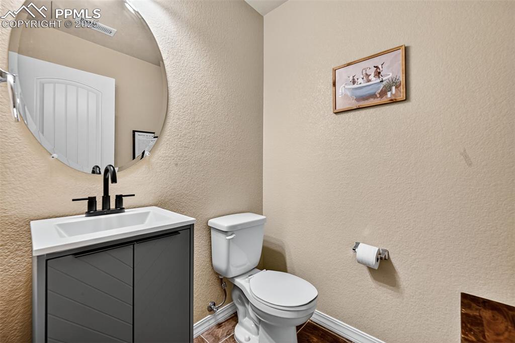 10859 Hidden Ridge Circle Peyton, CO 80831 - Photo 17 of 33 Half bathroom featuring a textured wall and vanity