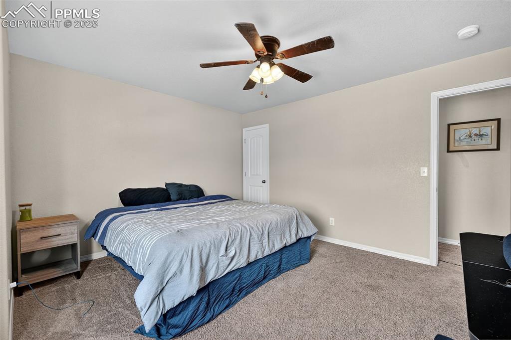 10859 Hidden Ridge Circle Peyton, CO 80831 - Photo 26 of 33 Bedroom featuring carpet floors and a ceiling fan