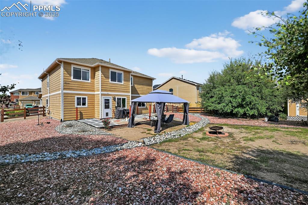 10859 Hidden Ridge Circle Peyton, CO 80831 - Photo 6 of 33 Rear view of property with a gazebo, a patio, and an outdoor fire pit