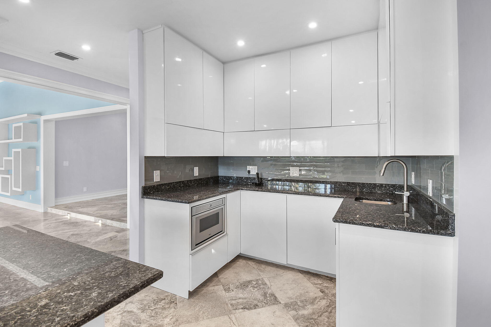 123 Olympus Way Jupiter, FL 33477 - Photo 40 of 116 a kitchen with granite countertop cabinets stainless steel appliances and a sink