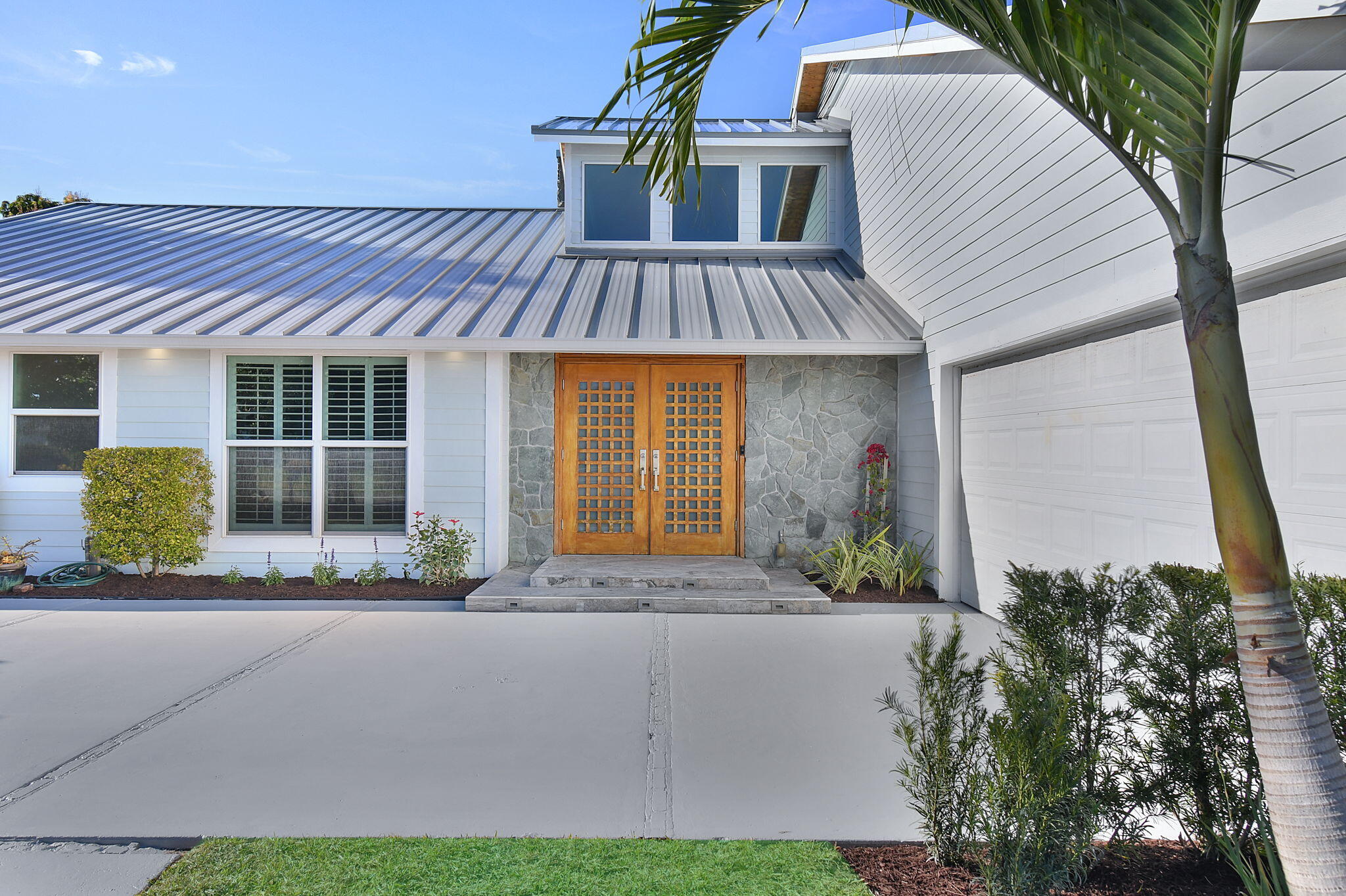 123 Olympus Way Jupiter, FL 33477 - Photo 52 of 116 a front view of a house with garden