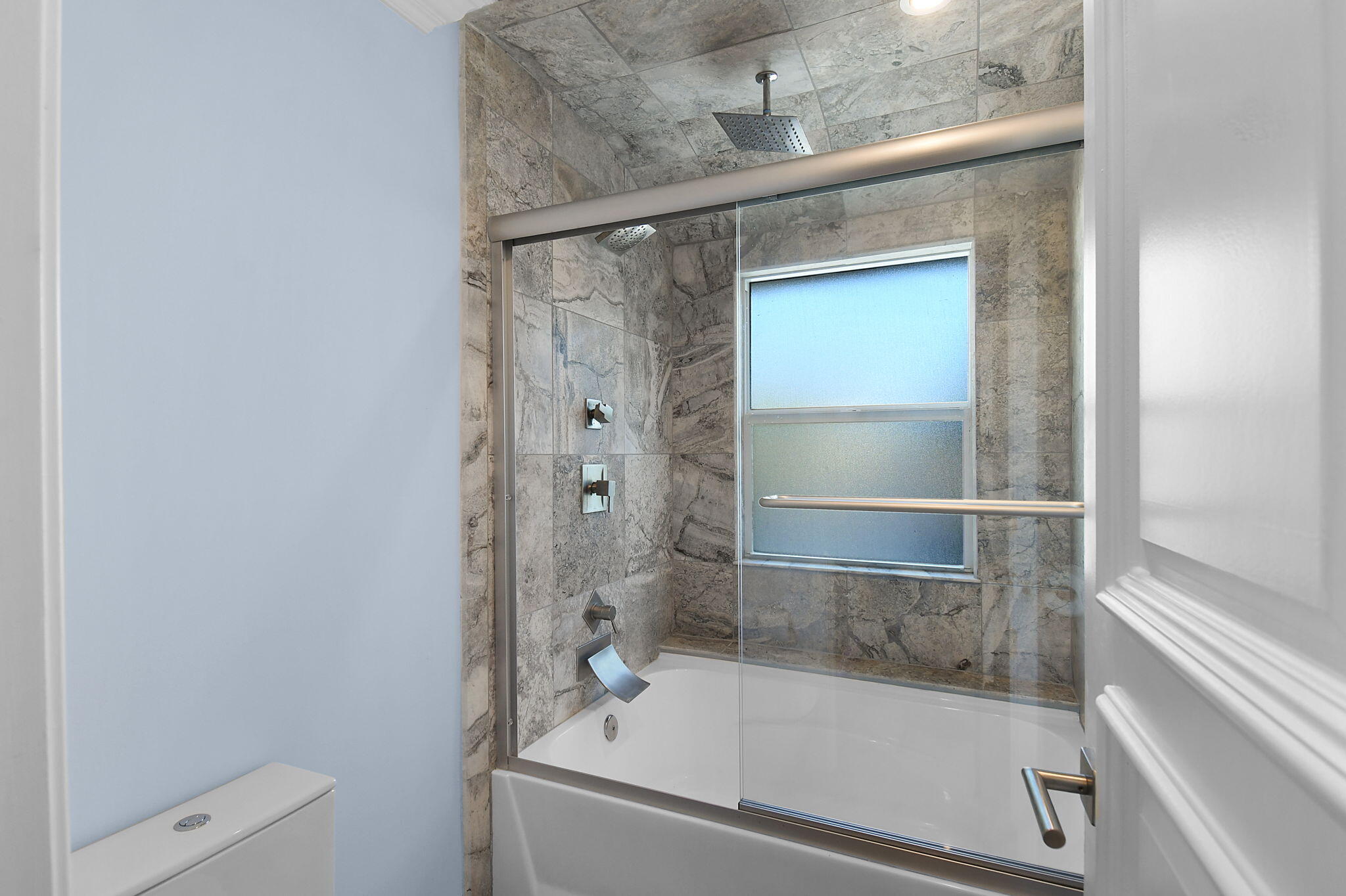 123 Olympus Way Jupiter, FL 33477 - Photo 76 of 116 a bathroom with a shower and toilet