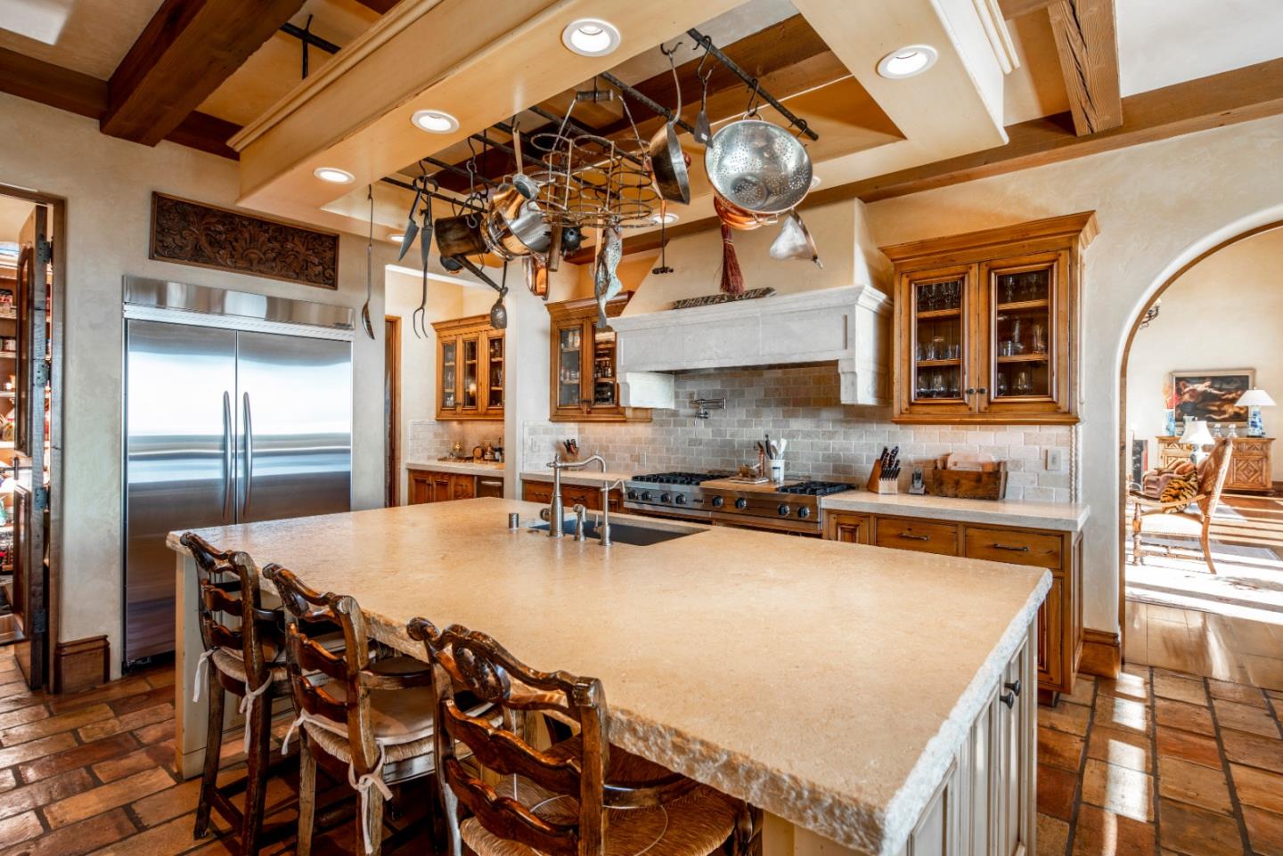 1504 Bonifacio Road Pebble Beach, CA 93953 - Photo 8 of 23 a kitchen with a table chairs and a wooden floor