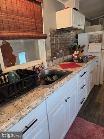 a kitchen with stainless steel appliances kitchen island granite countertop a sink and cabinets