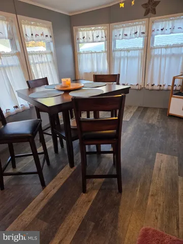 a view of a dining room with furniture and window