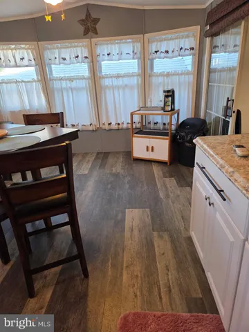 a living room with a bed furniture and a large window