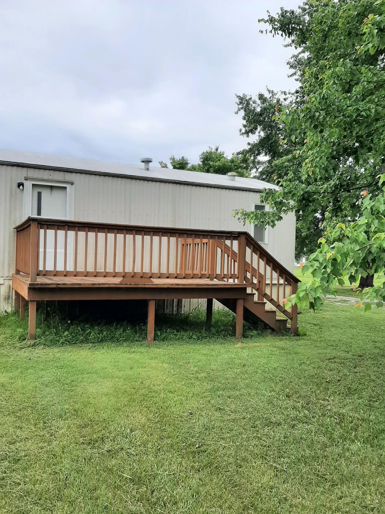 2006 Flat Woods Road Lebanon, TN 37090 - Photo 19 of 24 a view of a backyard with wooden fence and a bench
