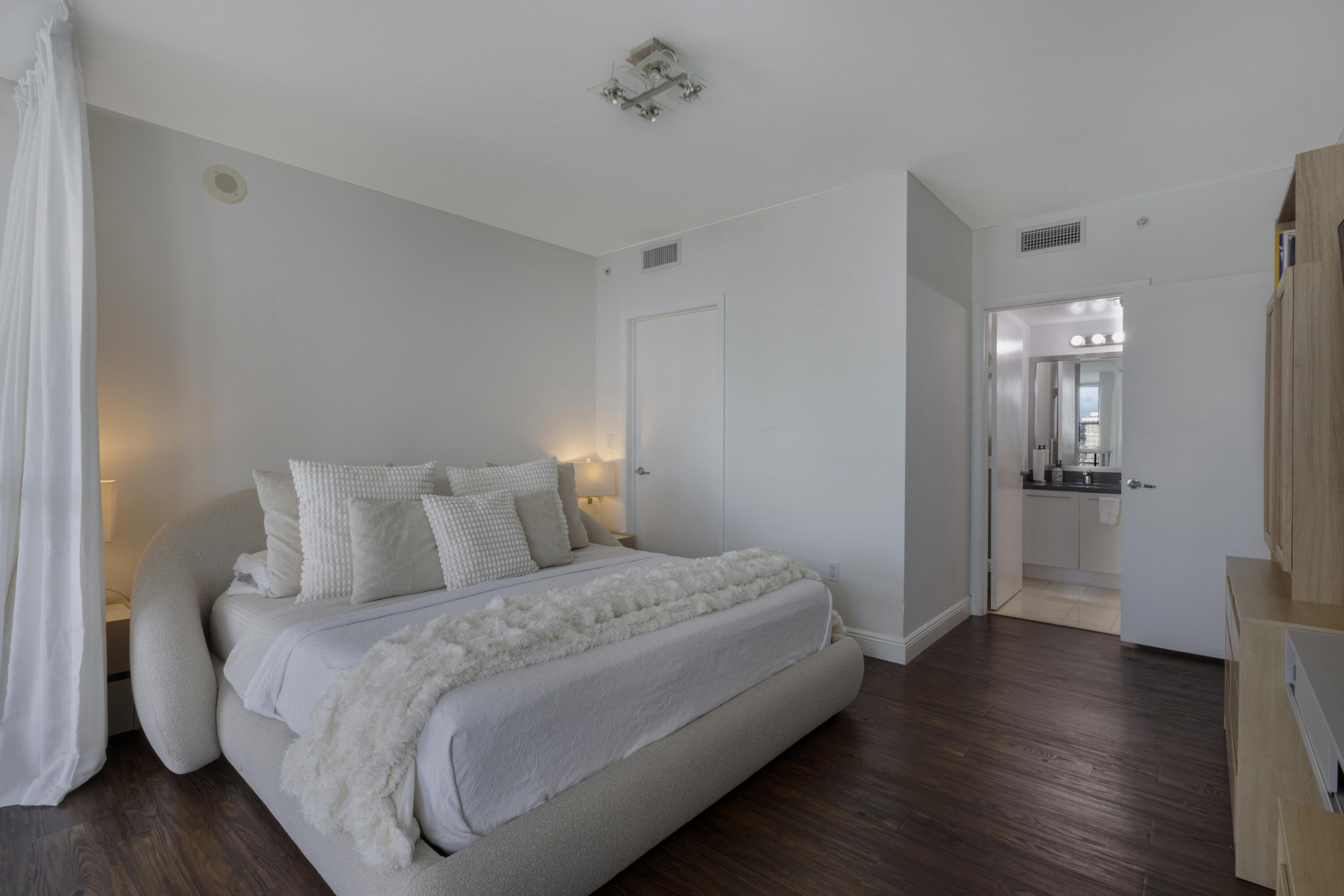 90 Southwest 3rd Street, Unit TH700A Miami, FL 33130 - Photo 4 of 32 a bedroom with a bed and wooden floor