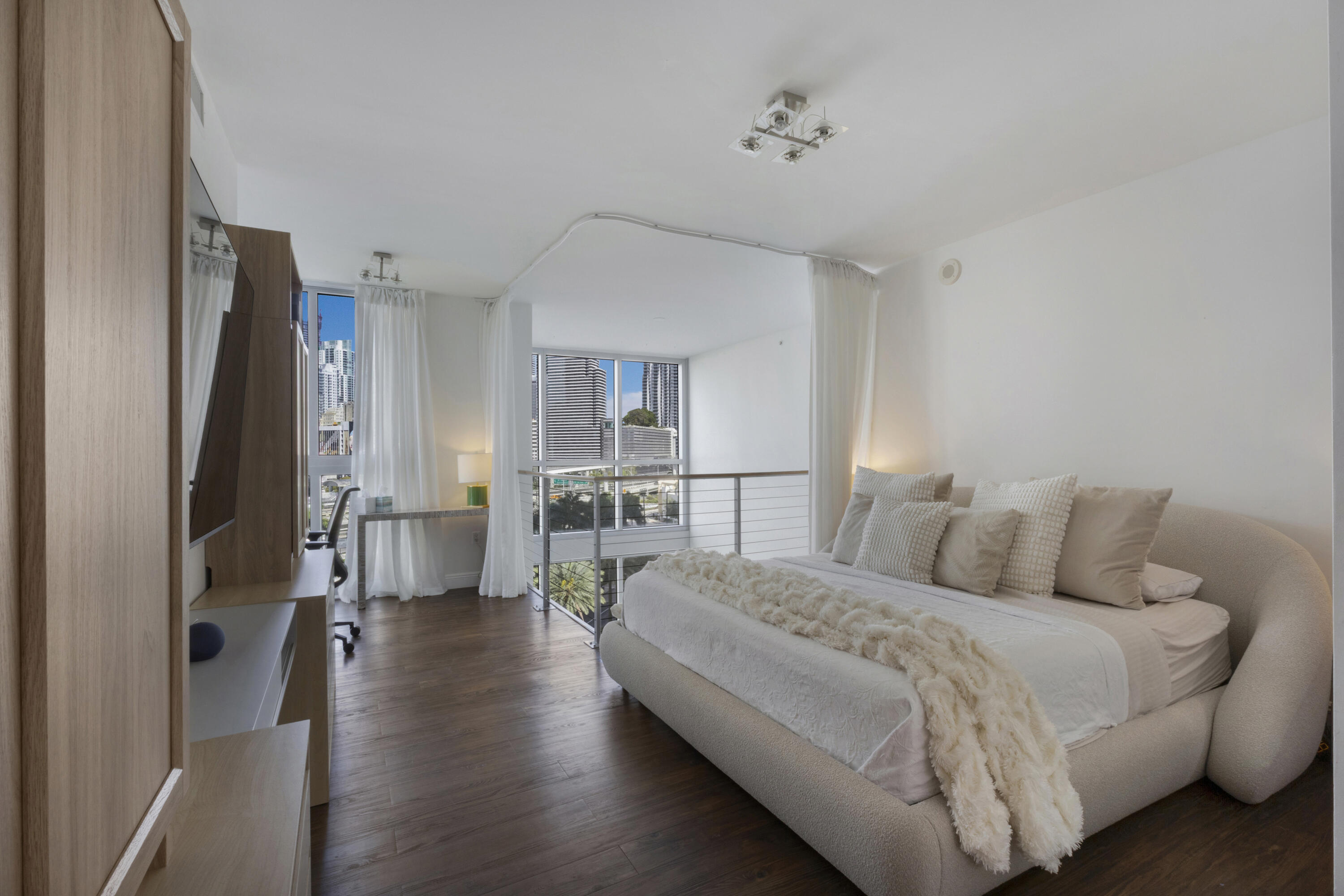 90 Southwest 3rd Street, Unit TH700A Miami, FL 33130 - Photo 5 of 32 a bed room with a bed and a chandelier