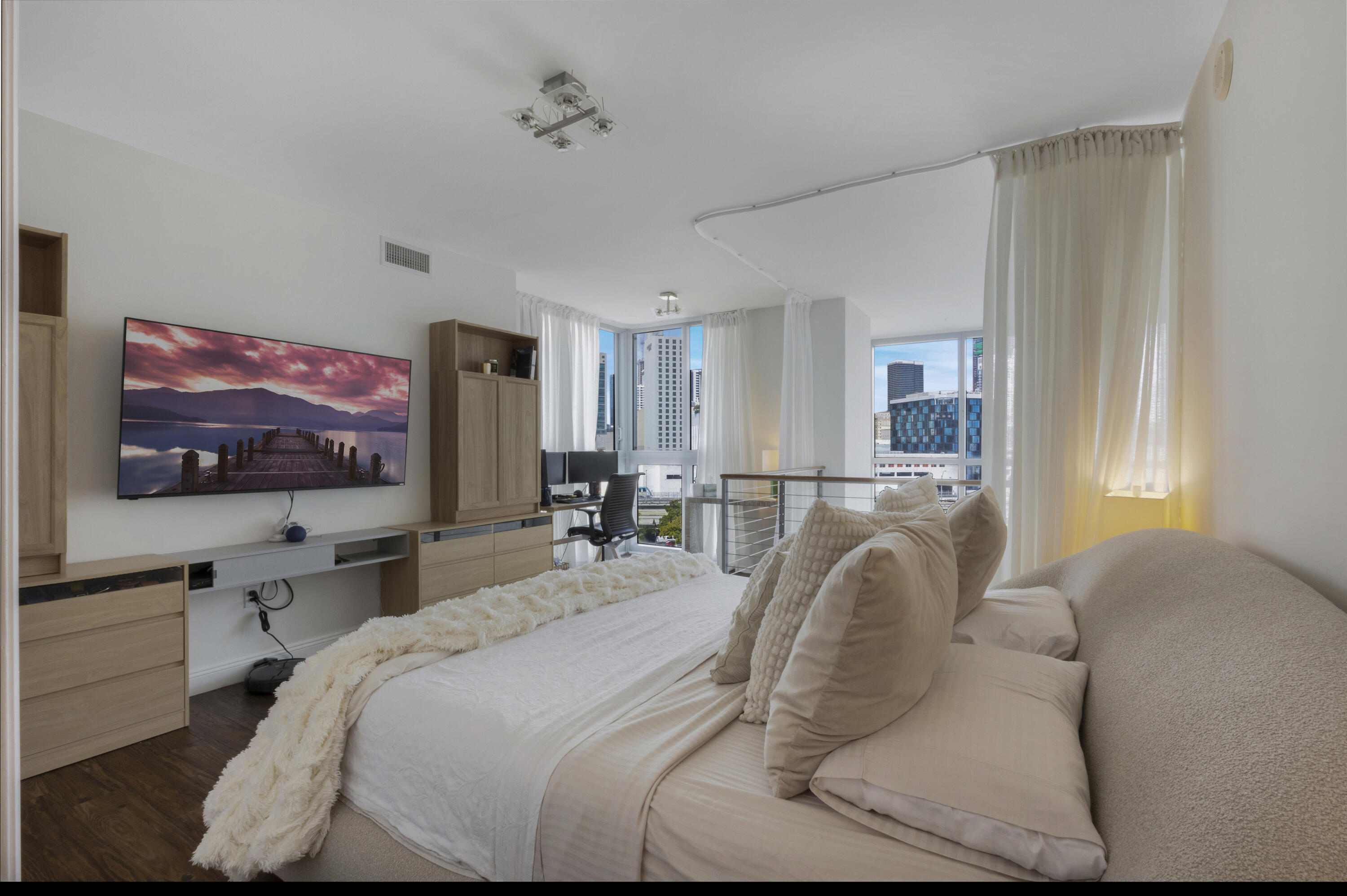 90 Southwest 3rd Street, Unit TH700A Miami, FL 33130 - Photo 6 of 32 a bedroom with a bed and a flat screen tv